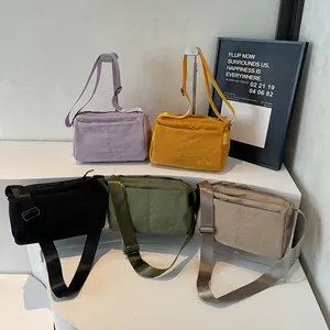 Waterproof nylon crossbody bags in five colors with adjustable shoulder straps and embroidery