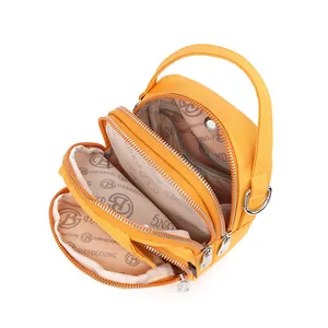Bright yellow multi-zipper crossbody bag with three compartments and compact design