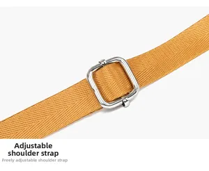 Macro shot of adjustable mustard yellow nylon woven strap with silver metal buckle