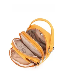 Top view of bright yellow handbag showing multi-zipper compartments and inner lining