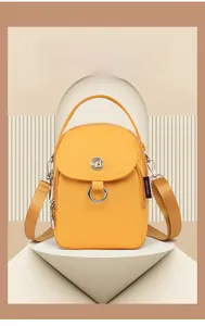 Detail of yellow nylon mini crossbody bag with metal logo and Made in China tag