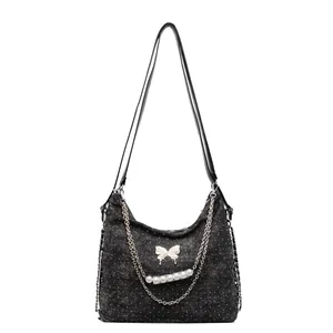 Elegant black sequin tote bag with silver butterfly buckle and pearl chain details