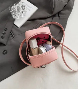 Pink glossy mini box bag interior showing capacity for cosmetics and small items