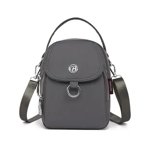 Deep grey mini crossbody phone bag with adjustable strap and metallic B logo