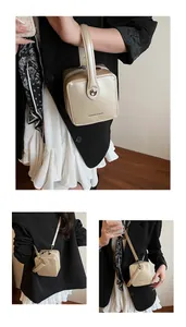 Champagne gold mini box bag shown in hand and crossbody styles on a model