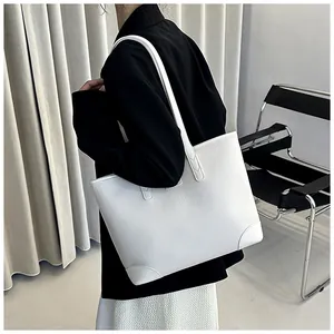 White litchi pattern leather tote bag shown on model with minimalist background