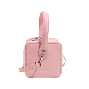 Pink patent leather square box handbag for women with silver hardware and shoulder strap