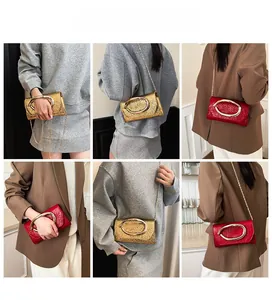 Multi-angle view of model wearing minimalist square bag with large oval gold handle