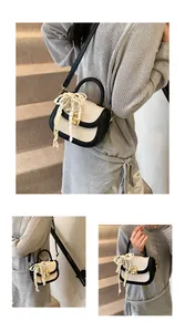 Détail d'un mini sac selle tissé avec un nœud en perles et un fermoir doré élégant