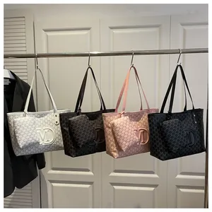 Detailed view of four colorful monogram tote bags with matching coin purses on display