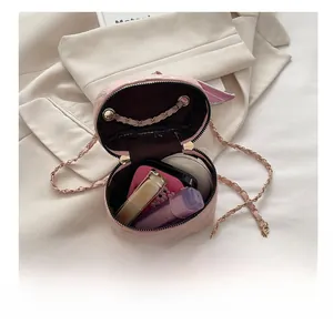 Interior view showing the storage capacity for cosmetics in a pink quilted chain bag