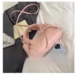 Detail showing soft pink bow tote bag size comparison with a mobile phone
