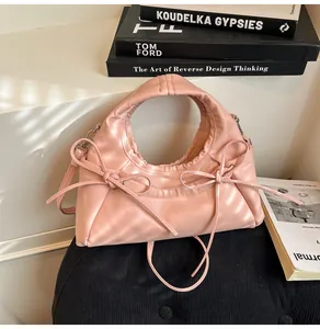Detailed view of pink bow tote bag with soft PU leather texture and shoulder strap
