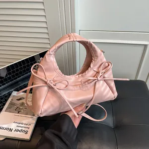 Pink tote bag with decorative bows and adjustable shoulder strap for women