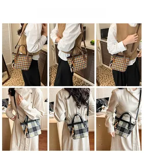 Detail view of plaid tote bag featuring checkered patterns and elegant tassel accessory
