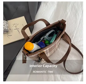 Detail view of large plaid tote bag interior showing ample storage for daily essentials