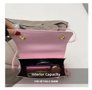 Macro detail of the pink shoulder bag internal capacity showing daily essentials
