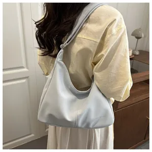 Detail of light blue hobo bag showing fine stitching and small dryness embossed logo