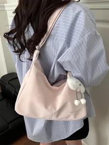 Pink minimalist faux leather shoulder bag with plush cloud charm and printed logo