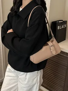 Minimalist beige faux leather shoulder bag for women featuring a stylish metal buckle strap