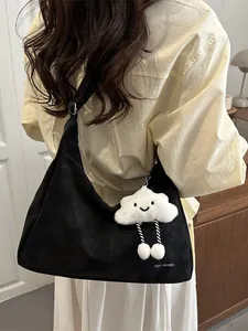 Minimalist black hobo shoulder bag with a white cloud plush charm and graphic text