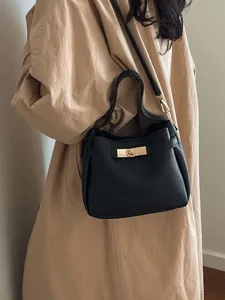 Classic black bucket bag with lychee texture and gold metal clasp for women