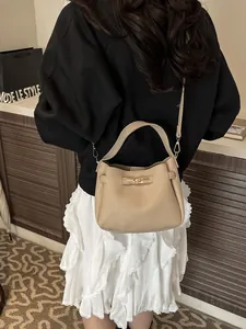 Chic beige lychee leather bucket bag with gold lock for women's stylish daily commute