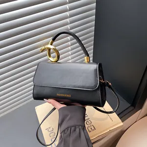 Minimalist black leather crossbody bag with golden knot handle and fashion slogan print