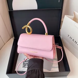 Pink minimalist crossbody handbag with golden metal handle and Fashion & Bags text logo