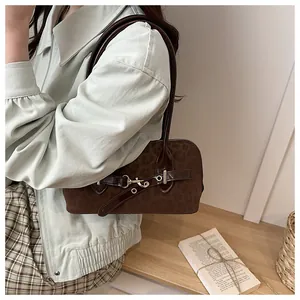 Detailansicht der Vintage-Schultertasche mit Leopardenmuster und Metallschnalle auf Holz