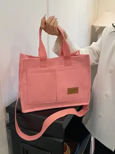 Pink canvas tote bag with adjustable shoulder strap and leather tag for women's daily commute
