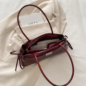 Interior view showing the large capacity of the burgundy glossy leather tote bag