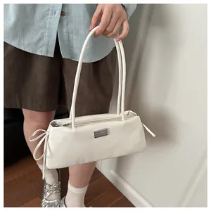 White rectangle leather shoulder bag with side bow ties and metal logo plate detail
