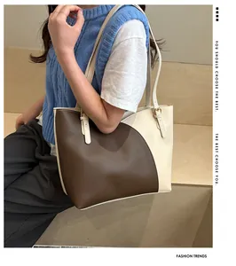 Detail of contrast color tote bag with circular arc stitching and adjustable metal buckle