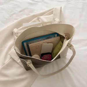 Interior view of large contrast tote bag showing storage for tablet, phone and umbrella