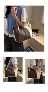 Close-up of adjustable strap and golden buckle on two-tone leather tote bag
