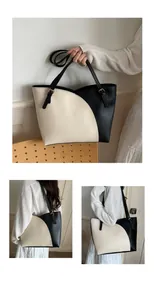 Detail of contrast color tote bag showing adjustable straps and smooth leather texture
