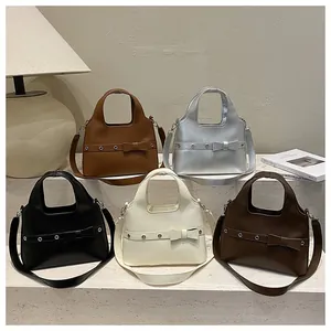 Detailed group shot of vintage bucket bags in five colors with bow detail and PU leather