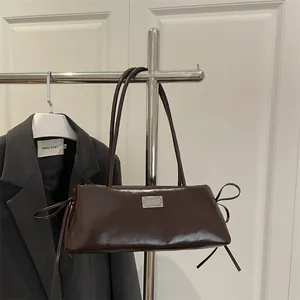 Chocolate brown baguette shoulder bag with double straps and side bow details