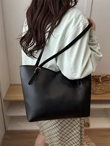 Minimalist large black contrast tote bag with adjustable straps for daily commuting