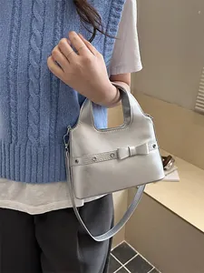 Silver metallic bucket bag with bow detail, stylish shoulder strap for women