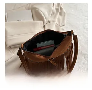 Detail view of bohemian fringe bag interior showing spacious capacity for daily essentials