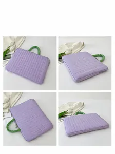 Detailed views of a quilted lavender laptop sleeve with green ruched handles and zipper