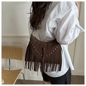 Close-up of bohemian brown fringe crossbody bag with silver studs and tassel details