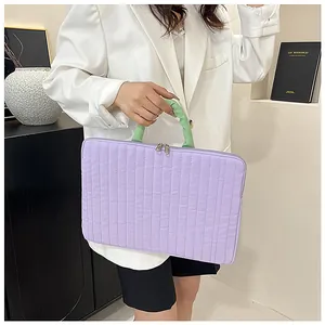 Close-up of quilted lavender tablet sleeve with contrasting green ruched handle detail