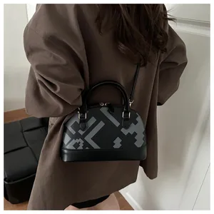 Detailed view of women's shell bag with vintage geometric patterns in a lifestyle setting