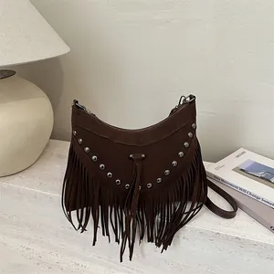 Bohemian dark brown suede crossbody bag featuring long fringes and silver rivets accents
