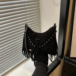 Bohemian style black suede crossbody bag with metallic studs and long tassels detail