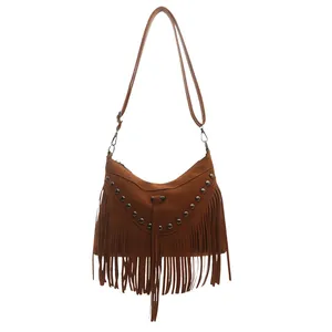 Brown bohemian tassel crossbody bag with metallic rivets and adjustable shoulder strap