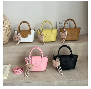 Multiple mini satchels with lychee texture and cute bear charms in various colors